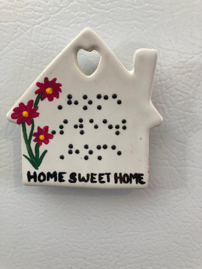 Home Sweet Home magnet- shown on gift wrap background