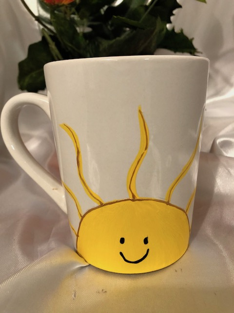 14oz. White mug with handpaintYellow Sunshine and smiling face with raised dot Braille message