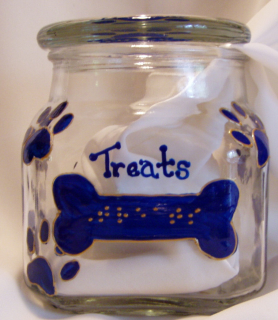 Jars are glass, square 1qt. size, with plastic seal on inside of lid to ensure freshness. The lid has a pawprint and the word "treats" in raised dot braille above the pawprint, and in script below the pawprint.  The pawprint design is outlined so the design can be felt all the way around the jar.  The front of the jar has a dog bone shape (also outlined) with the word "Treats" in raised dot braille.