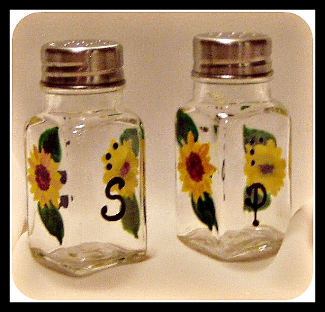 Salt and Pepper shakers with large S and P on each in Braille and script. Shown butterfly design on opposite sides of letters.