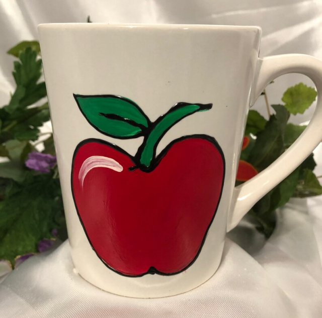 White mug with apple design (shown without personalization)