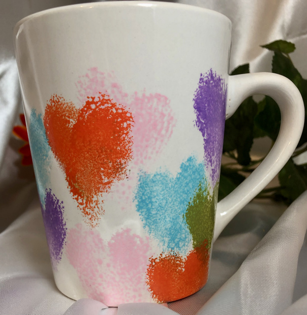 All around design of colorful hearts on mug
